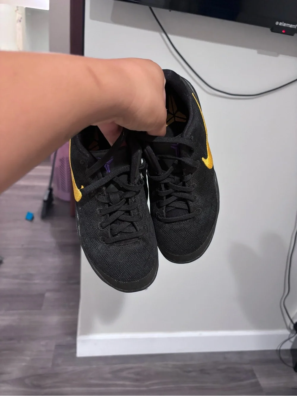 Nike Kids Black Sneakers with Gold Swoosh and Purple Heel